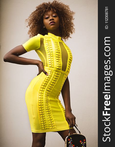 Curly Haired Woman in Yellow Bodycon Dress
