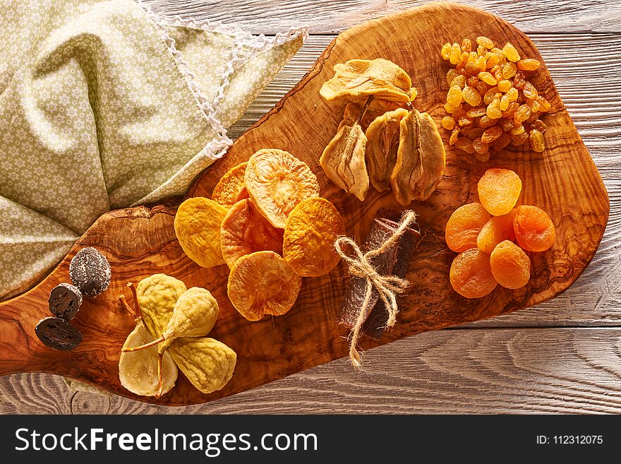 Dried fruits on vintage rustic wooden background. Dried fruits on vintage rustic wooden background