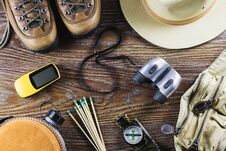 Hiking Or Travel Equipment With Boots, Compass, Binoculars, Matches On Wooden Background. Active Lifestyle Concept. Stock Photography