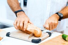 Male Hands Cutting Bread Royalty Free Stock Photos