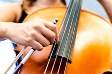 Close Up Of Cello With Bow In Hands Stock Photo