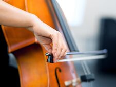 Close Up Of Cello With Bow In Hands Royalty Free Stock Photo
