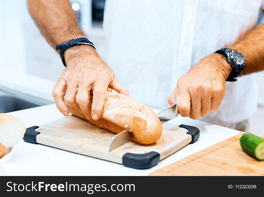 Male Hands Cutting Bread