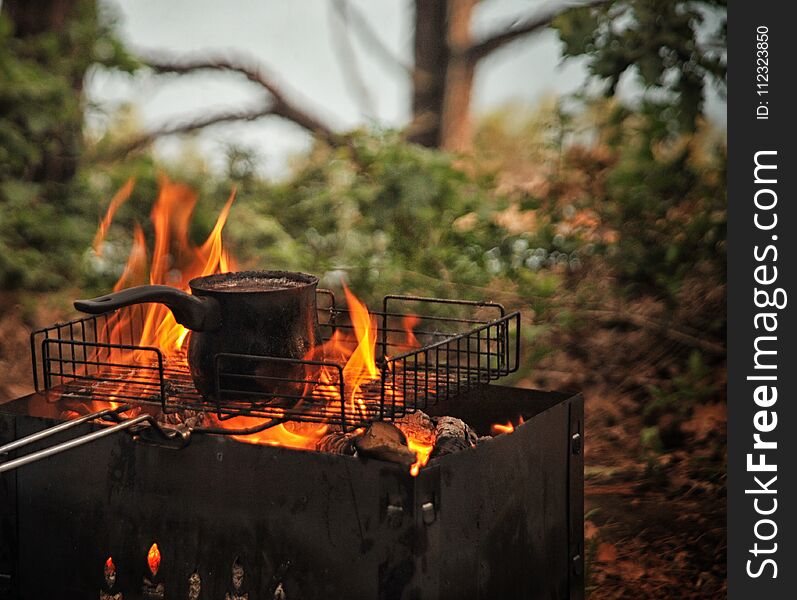 Close-up of black turkish coffee cooking on the fire