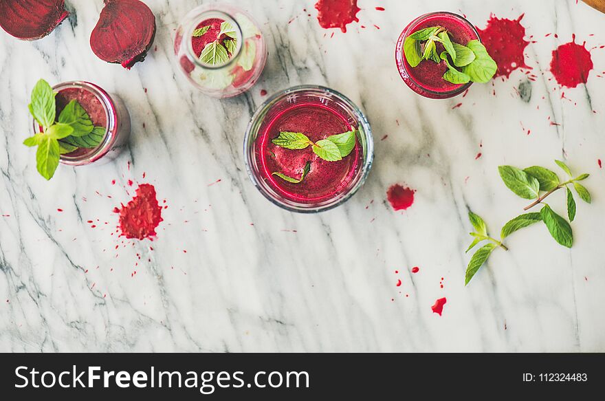 Fresh Beetroot Smoothie In Glasses Over Marble Background, Top View
