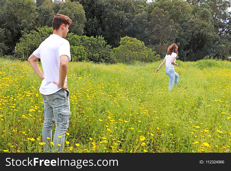 A Teenage Young Couple Having Fun In A Field Of Chrysanthemum