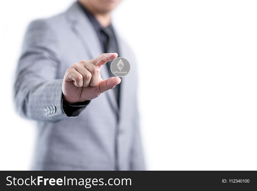 Businessman in gray suit is holding silver ethereum coin between fingers, smart contract crypto currency sign, isolated white background