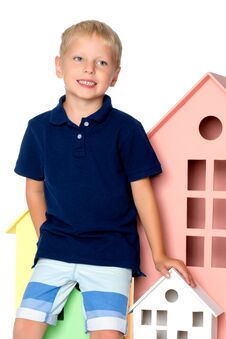 A Little Boy Is Playing With Colorful Houses. Royalty Free Stock Photography