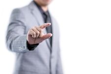 Businessman In Gray Suit Is Showing Something Between Fingers Royalty Free Stock Image