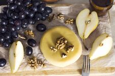 Cheese, Honey, Grapes, Pears And Nuts On Wooden Board On Kitchen Royalty Free Stock Images