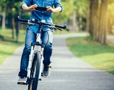 Cyclist Use Cellphone While Riding Bike Stock Images