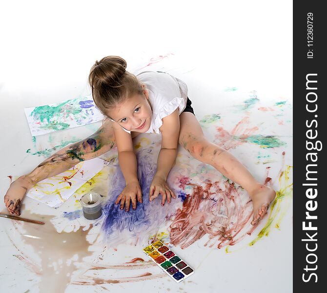 A little girl draws paints on her body. The concept of children`s creativity, education and school. on white background.