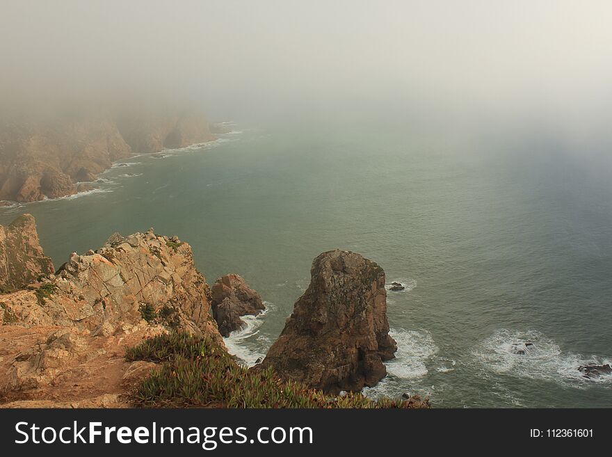 Fog. Cliffs Of Cabo Da Roca On The Atlantic Ocean In Sintra, Portugal, The Westernmost Point On The Continent Of Europe