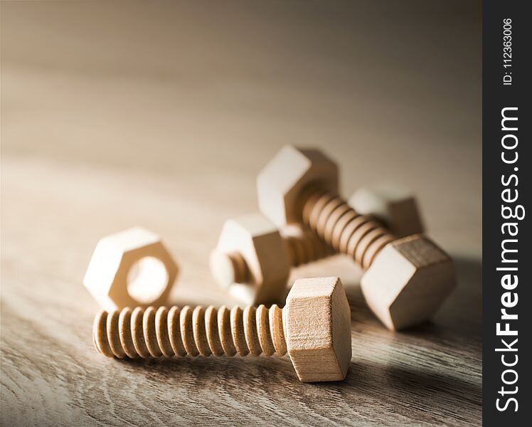 Wood nut and bolt on wood table work concept.