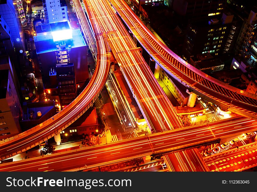 The highway in the big city, expressway enter the city, night light picture by drone on top view. The highway in the big city, expressway enter the city, night light picture by drone on top view.