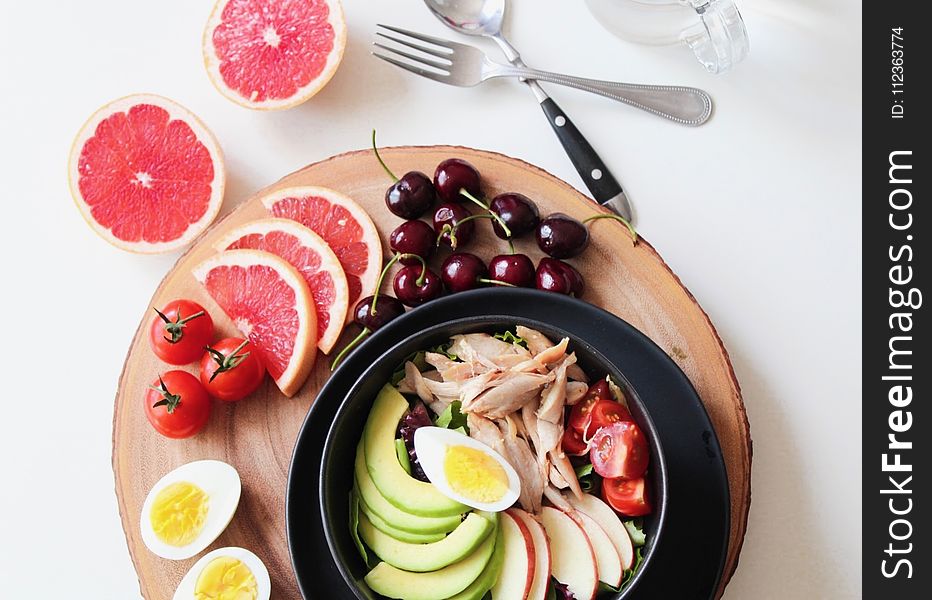 Bowl of Vegetable Salad and Fruits