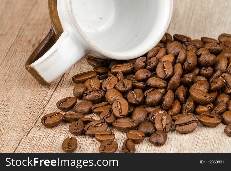Coffee Beans Beside White and Brown Ceramic Mug
