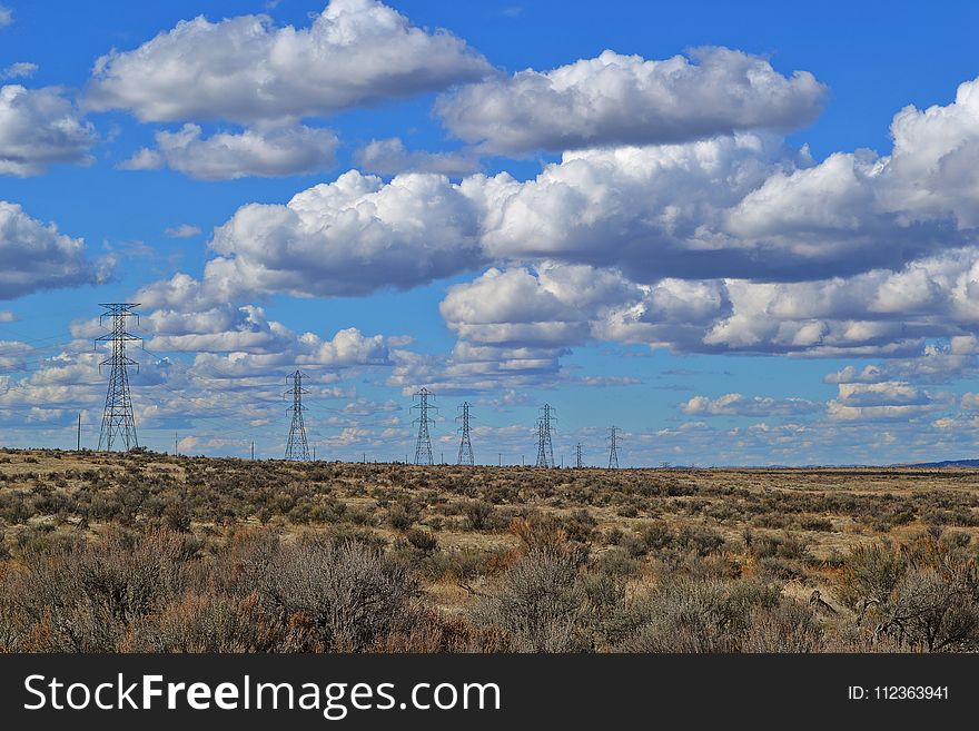 Black Electric Posts Under White Clouds