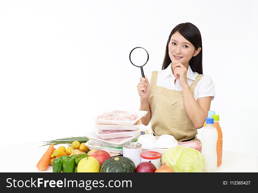 Smiling woman in apron with foodstuff. Smiling woman in apron with foodstuff