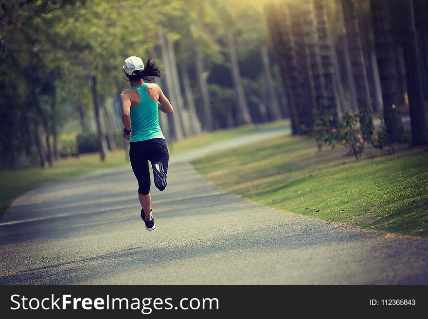Sporty fitness woman running at park. Sporty fitness woman running at park