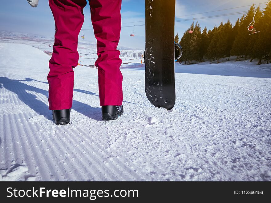 Snowboarder With Snowboard On Ski Slope