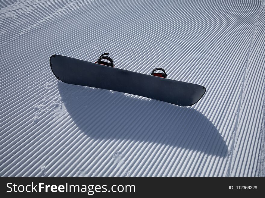 Snowboard On Ski Piste In Winter