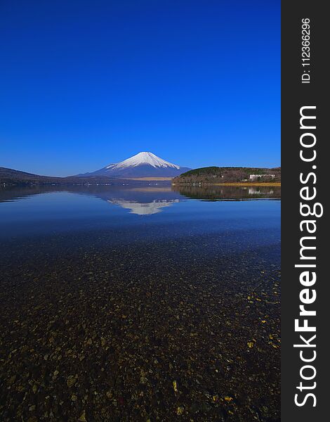 Mt. Fuji of Transparent water with Blue Sky from Lake Yamanakako Japan