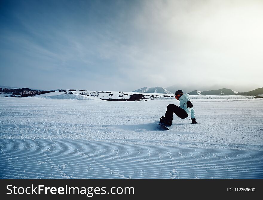 Snowboarder Snowboarding In Winter Mountains