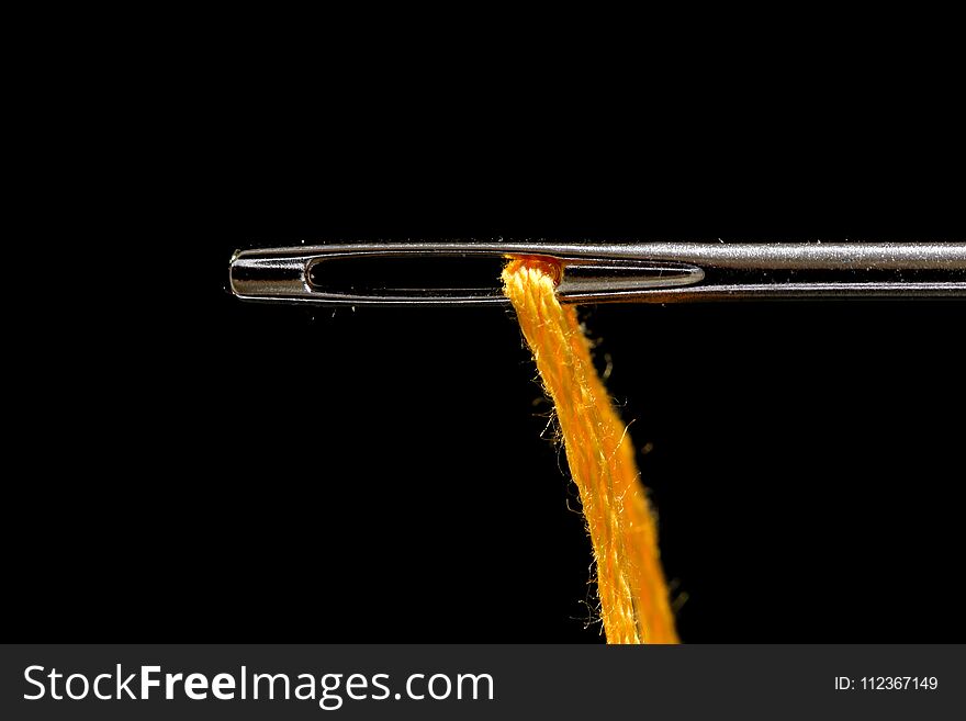 Extreme close up shot of needle and thread