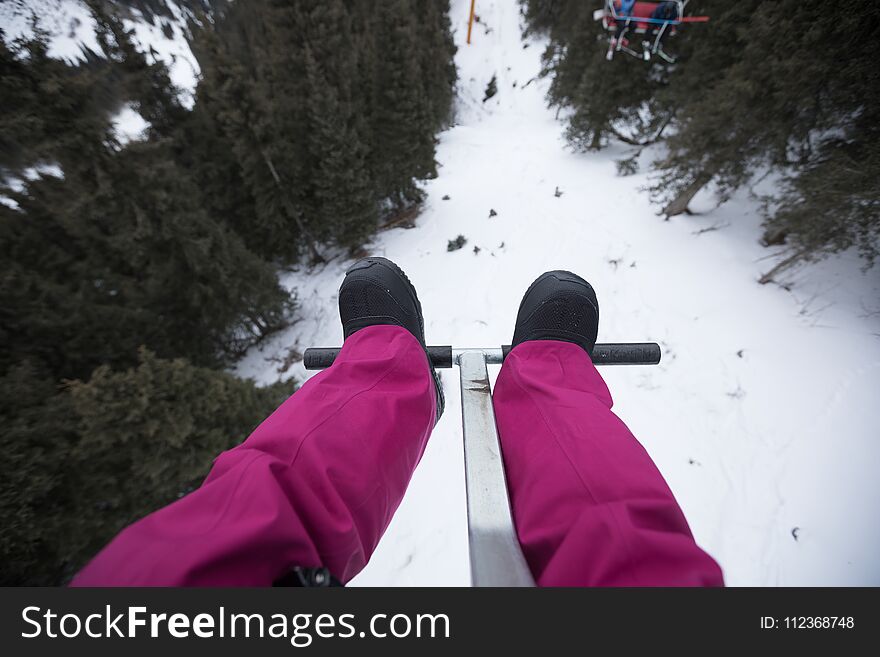 legs on cable car over the mountains in ski resort