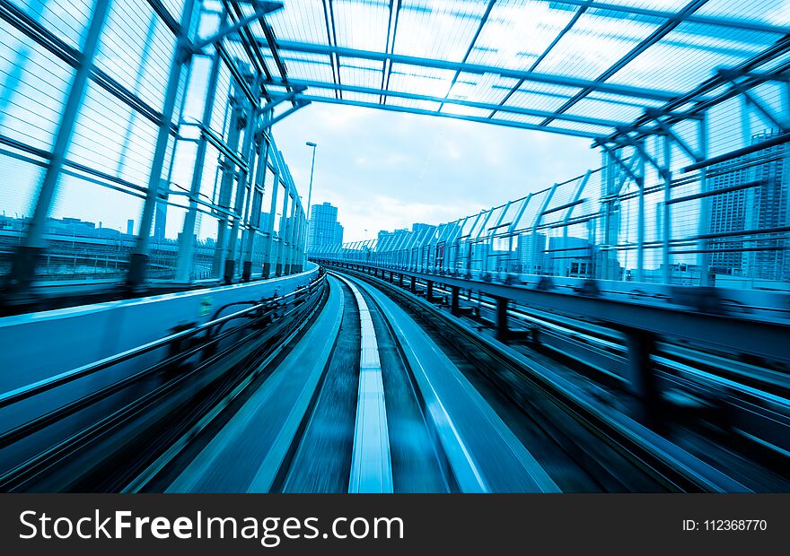 Front view of train moving in city rail tunnel with moderate motion blur and blue tone filter. Transportation concept and motion blur background abstract. Front view of train moving in city rail tunnel with moderate motion blur and blue tone filter. Transportation concept and motion blur background abstract.