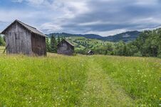 Wooden Barns On A Blooming Meadow Stock Photos