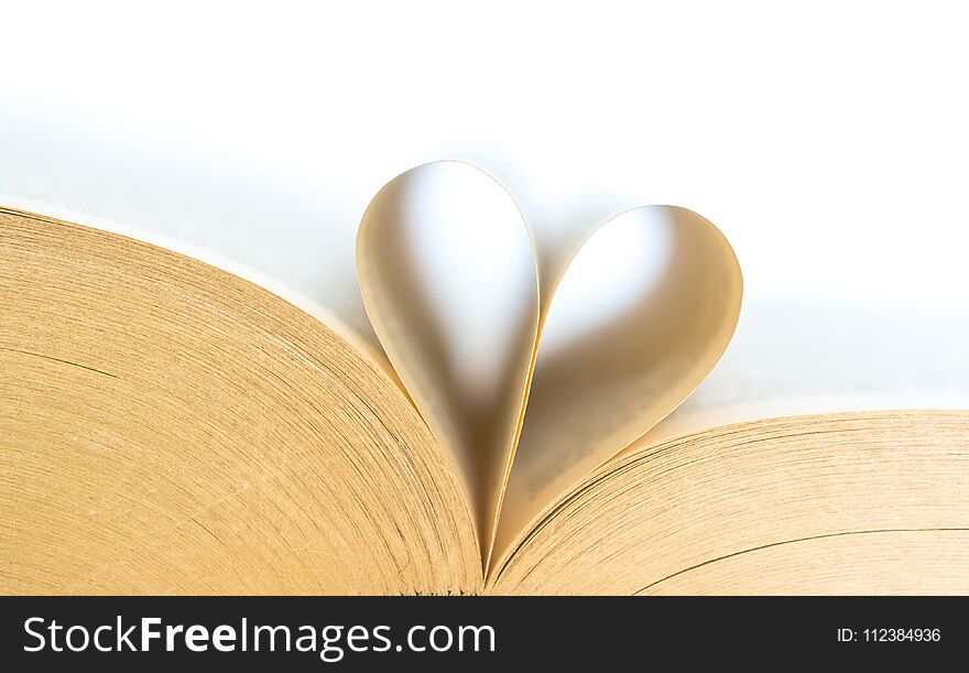 Book with opened pages of shape of heart isolated on white background. Love read concept. Knowledge symbol. Book day