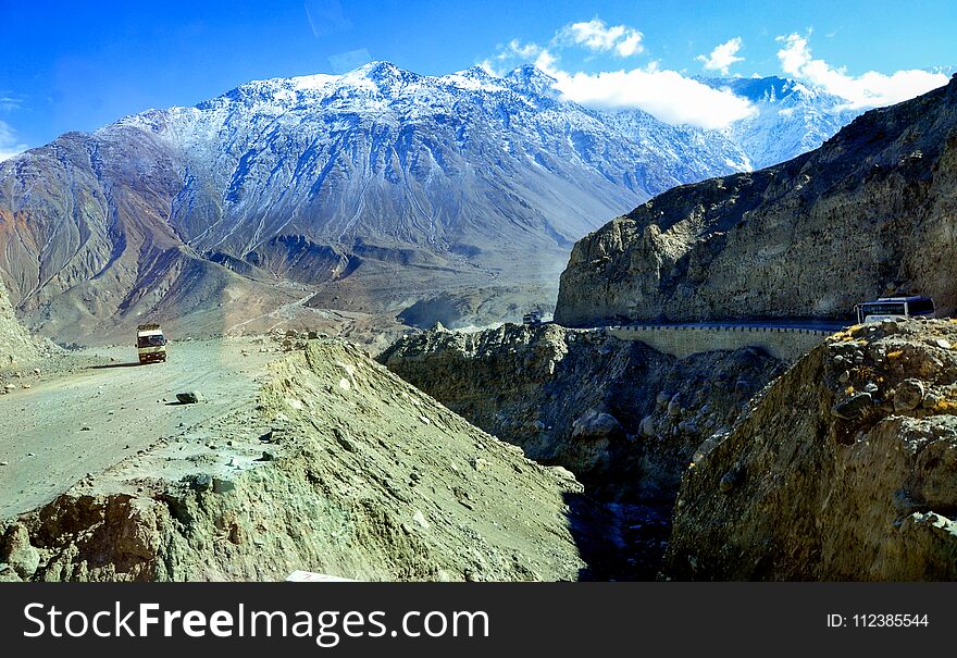 The Karakorum highway among the snow capped peaks and mountains. The Karakorum highway among the snow capped peaks and mountains