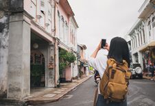 Traveler Backpacker Use Mobile Phone Taking Photo Of Old Town Ci Royalty Free Stock Images