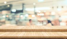 Empty Step Plank Wood Table Top Food Stand With Blur Cafe Restaurant Background Bokeh Light,Mock Up For Product Display Or Stock Photo Empty Step Plank Wood Table Top Food Stand With Blur Cafe Restaurant Background Bokeh Light,Mock Up For Product Display Or Stock Photo