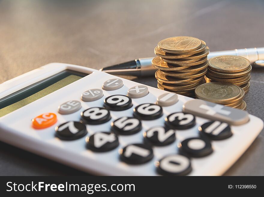 Saving money concept with money coin stack growing and calculator for business and accounting concept.