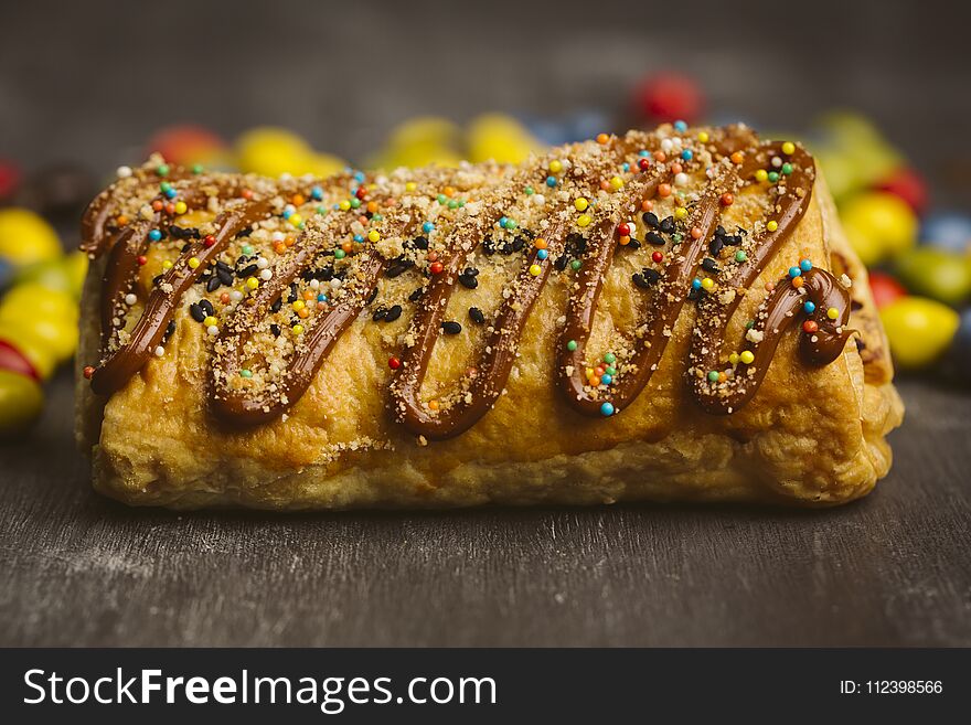 Sugary cake on a wooden dark background. Sugary cake on a wooden dark background.