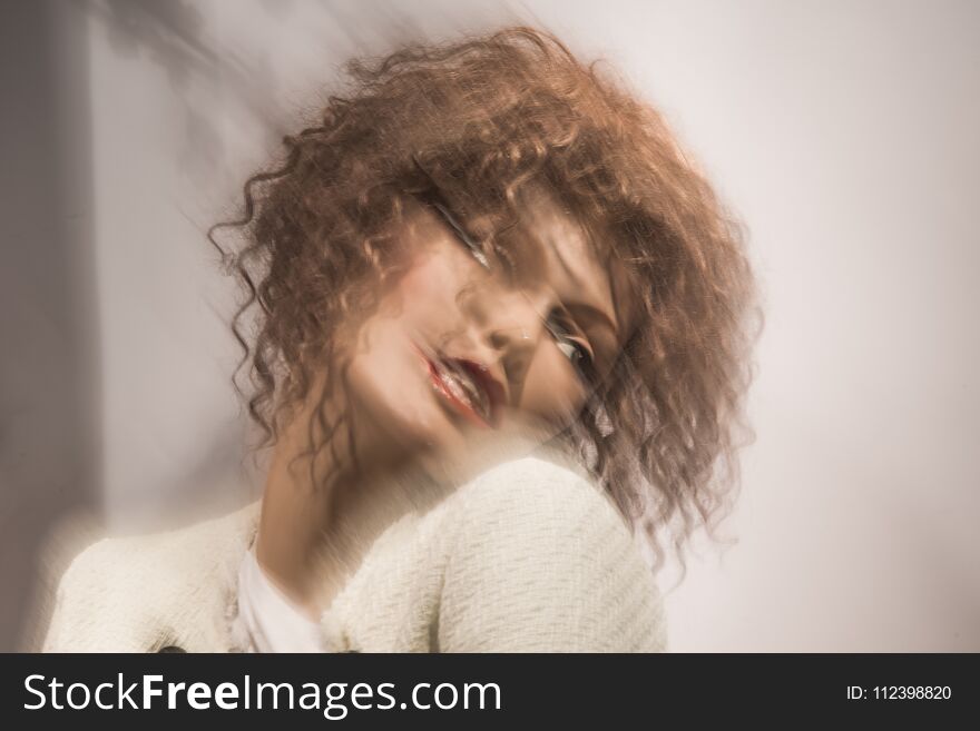 Motion blur and portrait of a woman with dark blond brown curly hair. Motion blur and portrait of a woman with dark blond brown curly hair