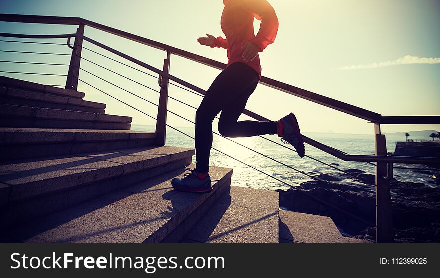 Runner running upstairs on coast trail