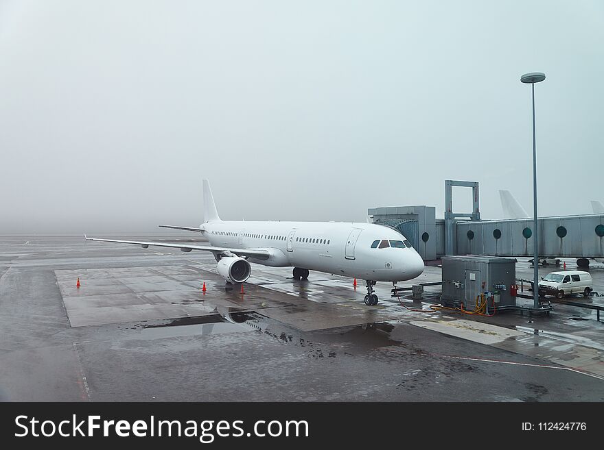 Plane at the airport in fog. Plane at the airport in fog