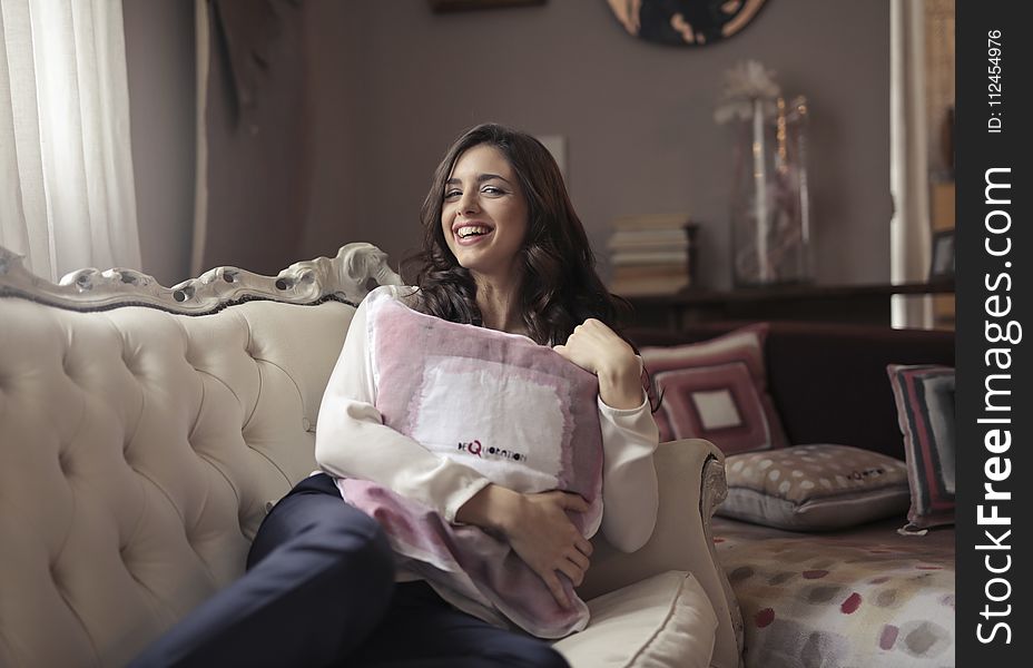 Photo of a Woman Sitting on the Couch