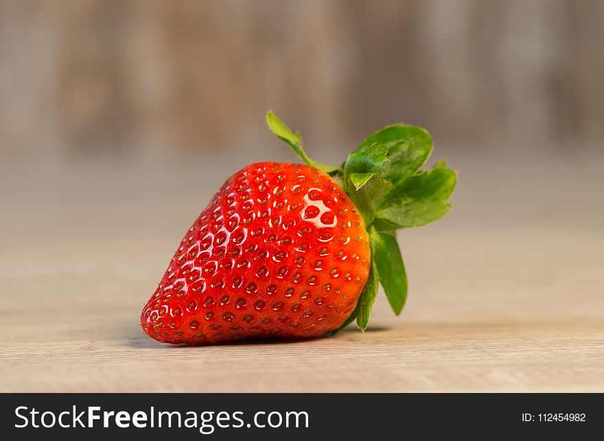 Strawberry Fruit on Brown Wooden Surface