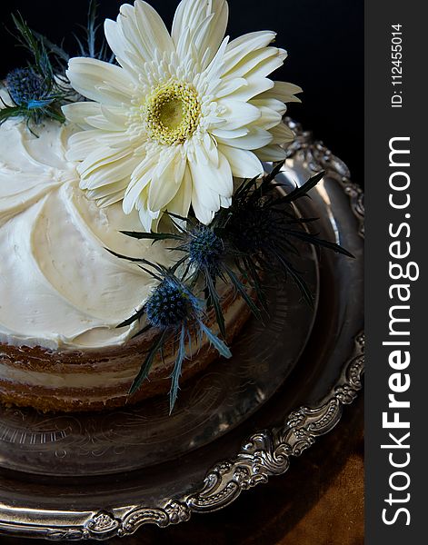 White Flowers on Round Cake With White Cream