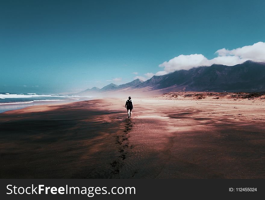 Photo Of Person Walking On Deserted Island