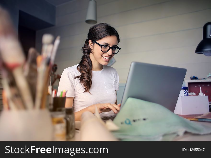 Photo of Woman Using Her Laptop