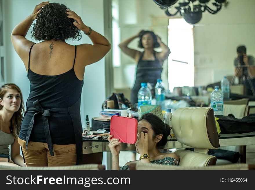 Woman In Black Spaghetti Strap Top Beside Woman Sitting Holding Pink Mirror