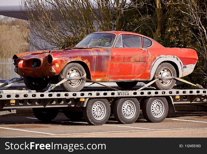 Red Coupe on Flatbed Trailer