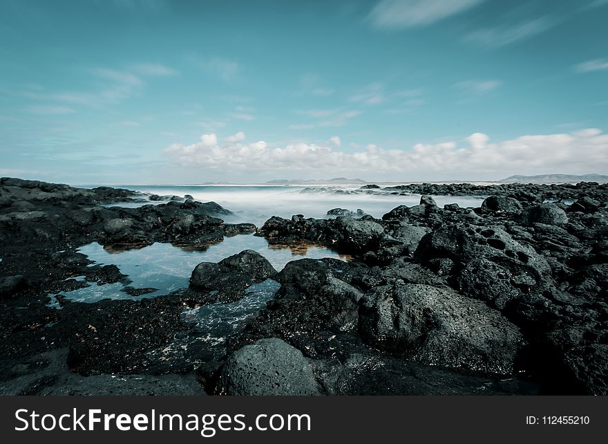 Seashore Under Blue Sky And White Clouds View