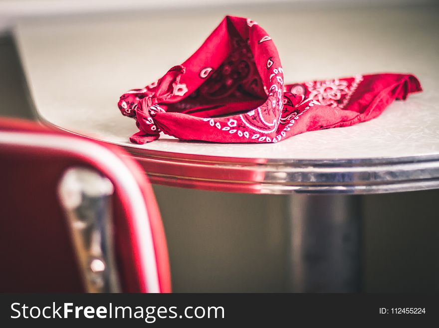 Red Paisley Handkerchief On Gray And White Table